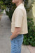 Double-breasted cropped blouse in light beige — main image