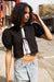 Cropped blouse with bow pattern in black — main image