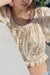 Plaid peplum blouse in beige — image