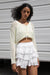 Cropped crochet cardigan in pale yellow — main image