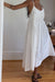Midi dress with asymmetrical ruching in white — main image