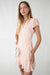 Floral wrap mini dress with ruffled hem in light rose floral — main image
