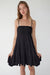 Smocked tiered mini dress in black — main image