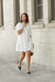Collared button front tiered dress in white — main image