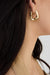 Square twist huggie earrings in gold — main image