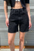 Mid thigh black jean short in washed black — main image