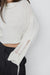 Distressed turtleneck sweater in beige — main image