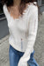 Distressed v-neck sweater in cream — main image
