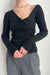Off shoulder front twist sweater in black — main image