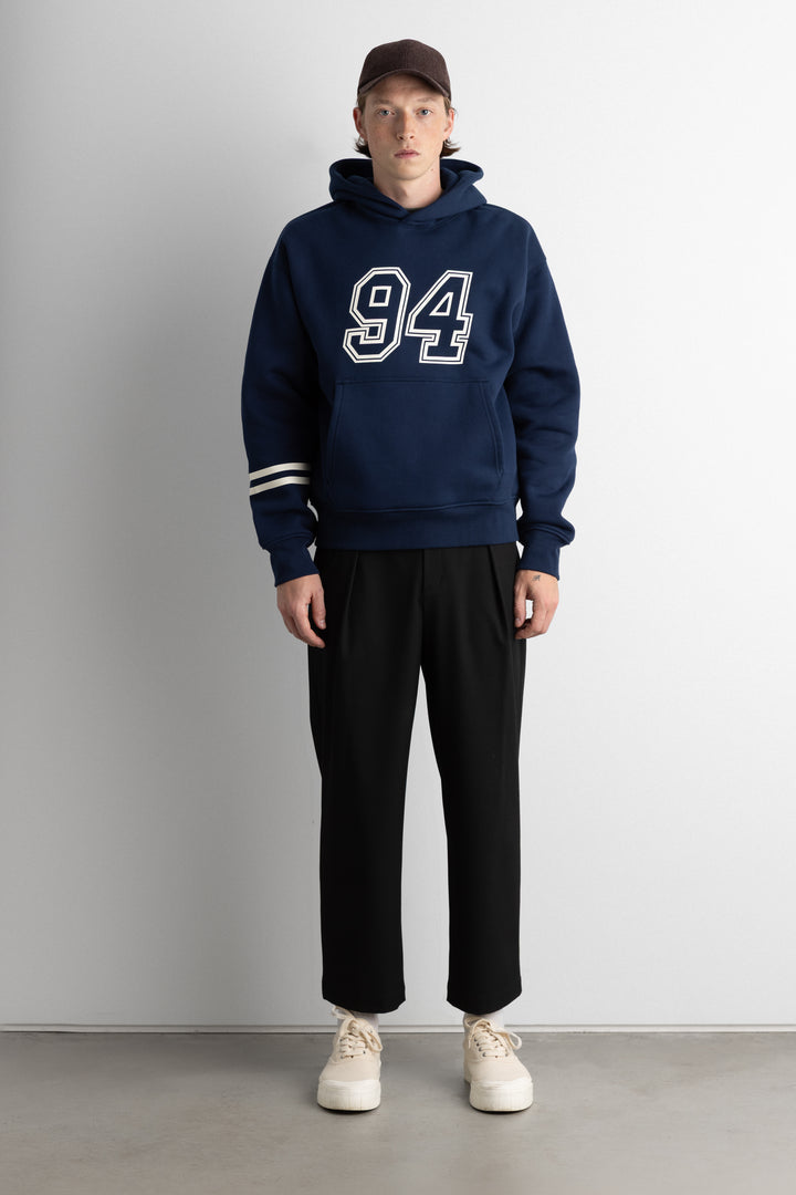 RELAXED VARSITY GRAPHIC HOODIE in Navy Blue — alternate angle