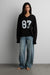 Graphic print v-neck long sleeve in black — main image