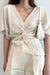 Pleated front twist top in almond milk — main image