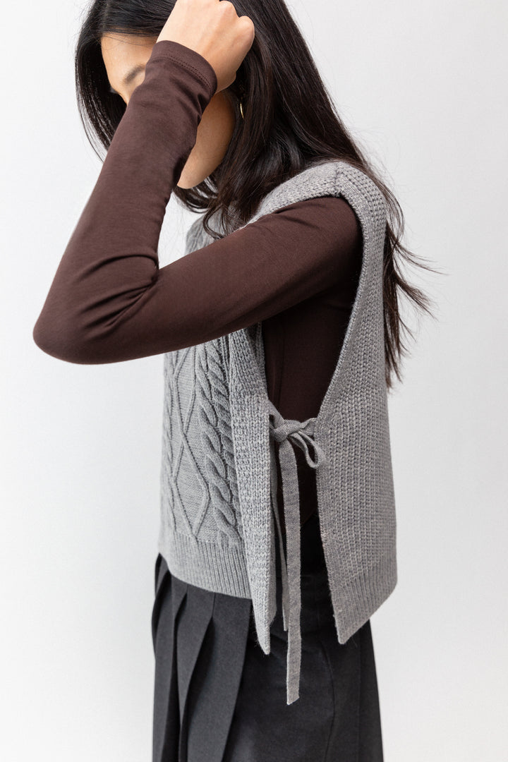 SLEEVELESS CABLE-KNIT VEST WITH TIES